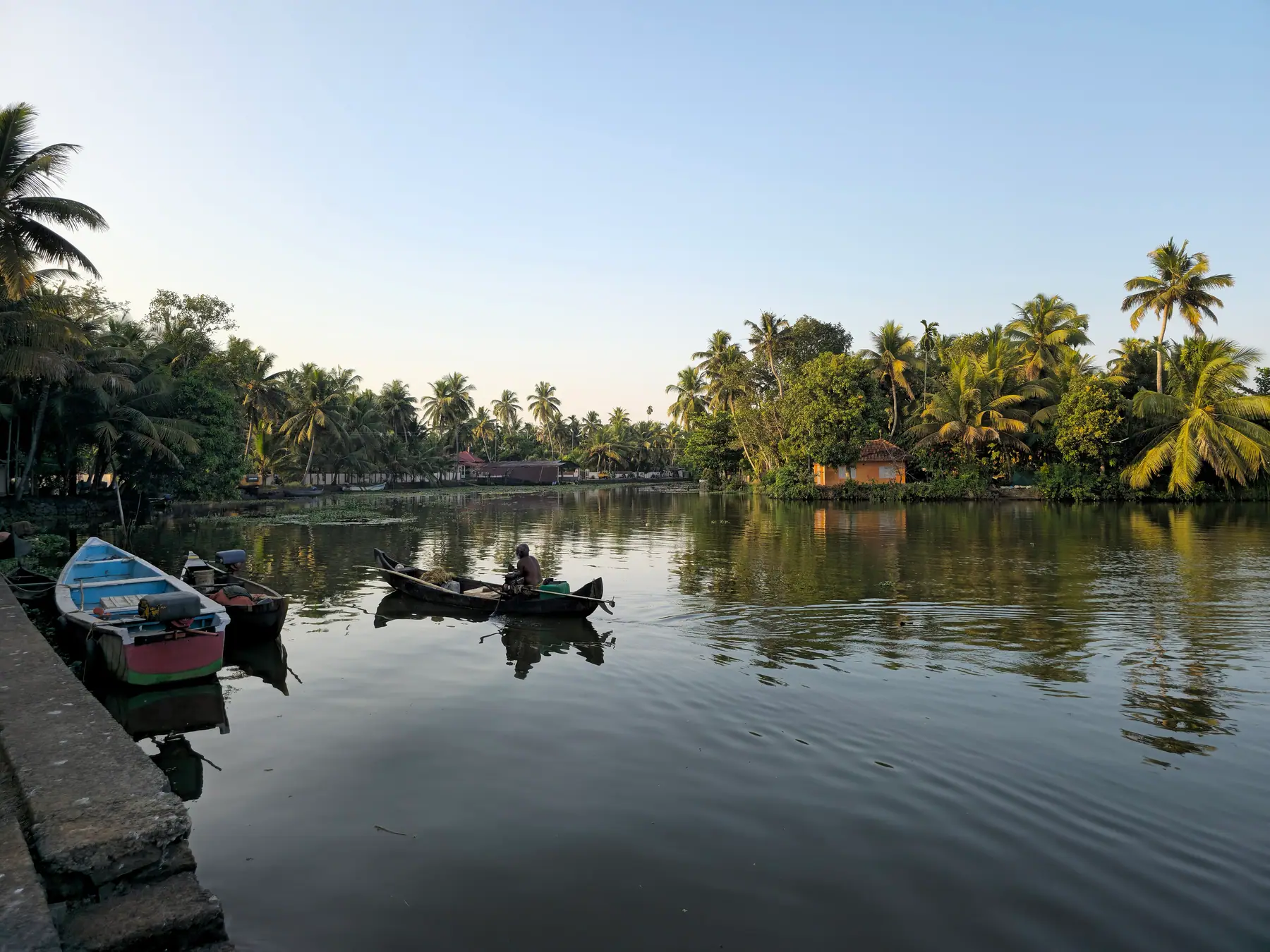 Canoes resting on a still backwater at Kumarakom, Kerala