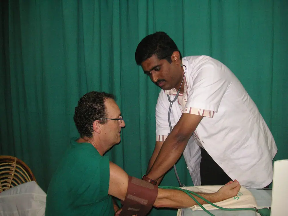 An Ayurveda doctor checking a guest’s blood pressure and pulse during a cure at Somatheeram