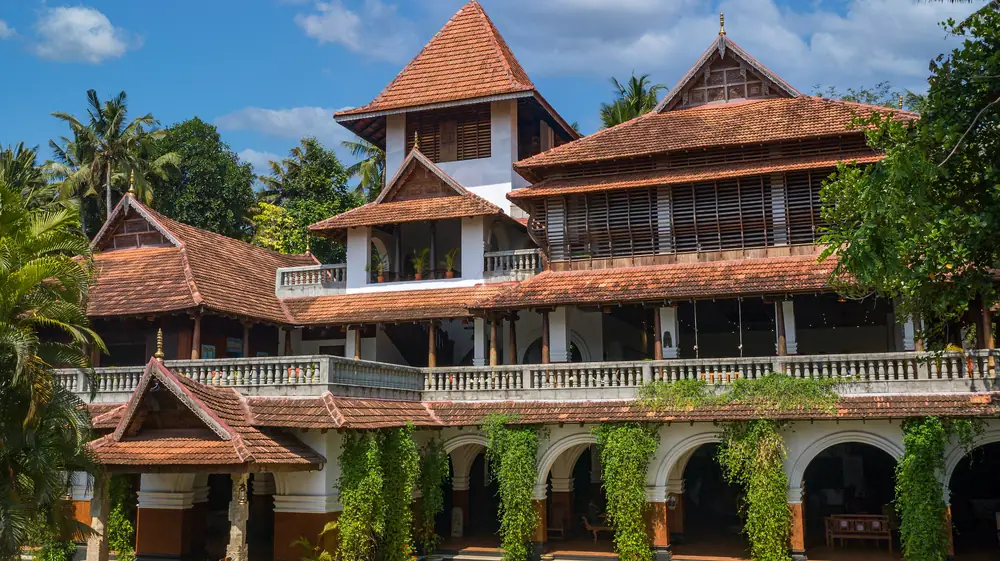 The main building at Somatheeram: red-tiled Kerala roofs over arched verandas