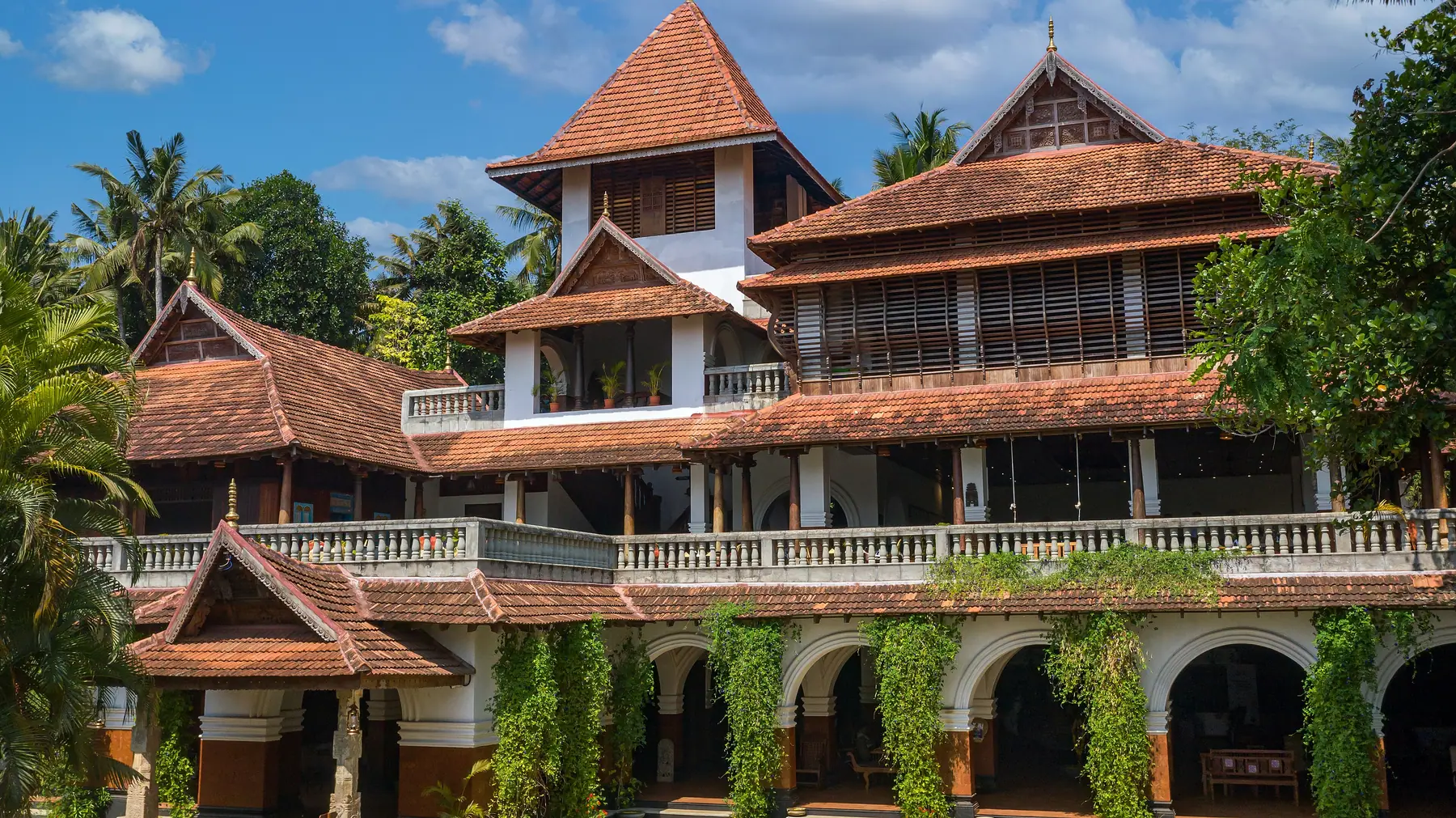 The main building at Somatheeram: red-tiled Kerala roofs over arched verandas